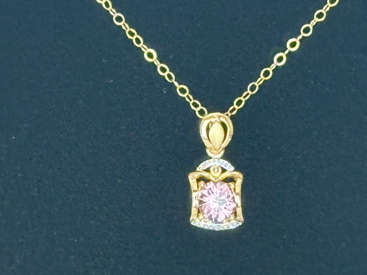 A dainty pinkish red spinel in gold pendant