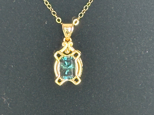 Blue Tourmaline set in a hand made 14K gold pendant.